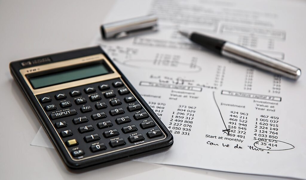 Calculator and pen on insurance paperwork