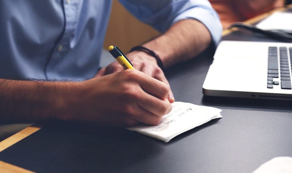 Man taking notes at a desk