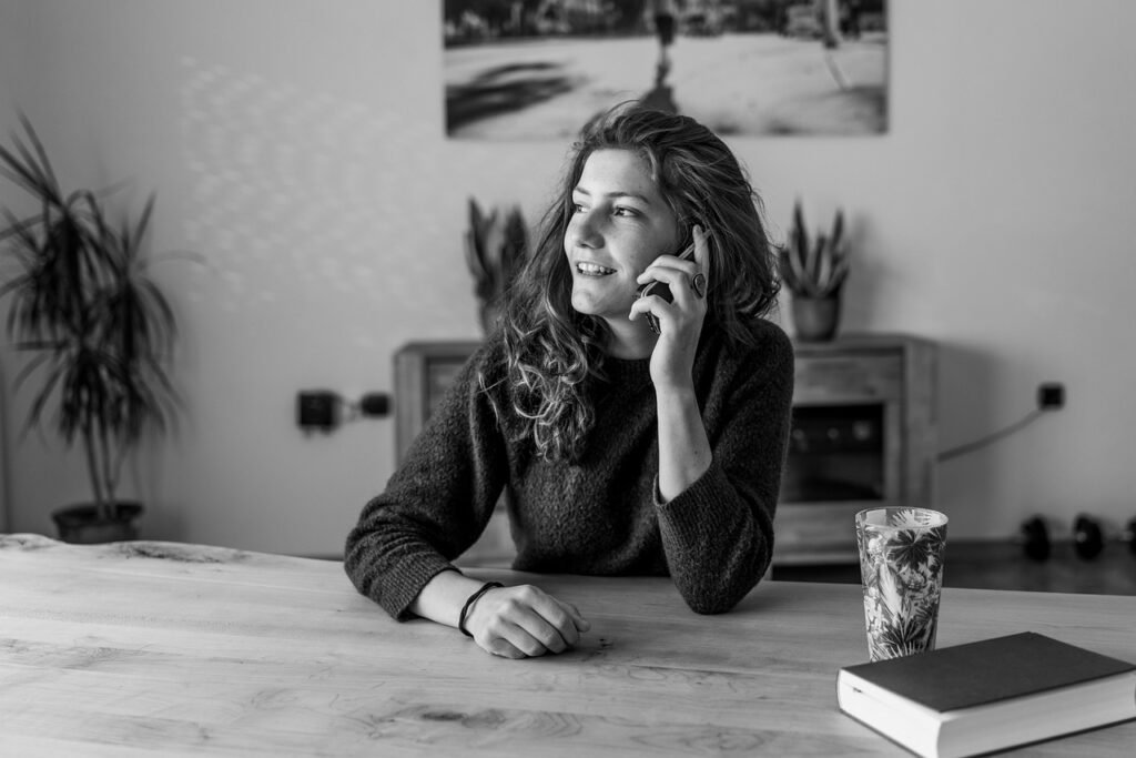 Woman making a phone call at a table